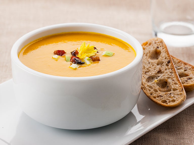 Suppe mit Topping und Brot